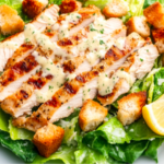 Freshly prepared Chicken Caesar Salad with grilled chicken and croutons.